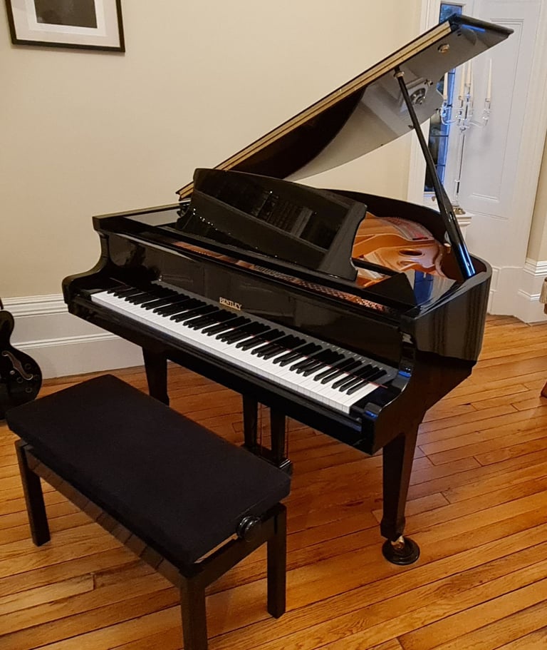 image for Bentley baby grand piano, black with stool and music books.