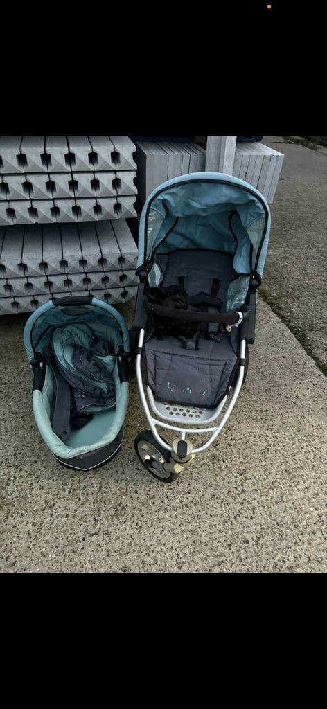 Quinny Grey and blue baby stroller with detachable car seat.