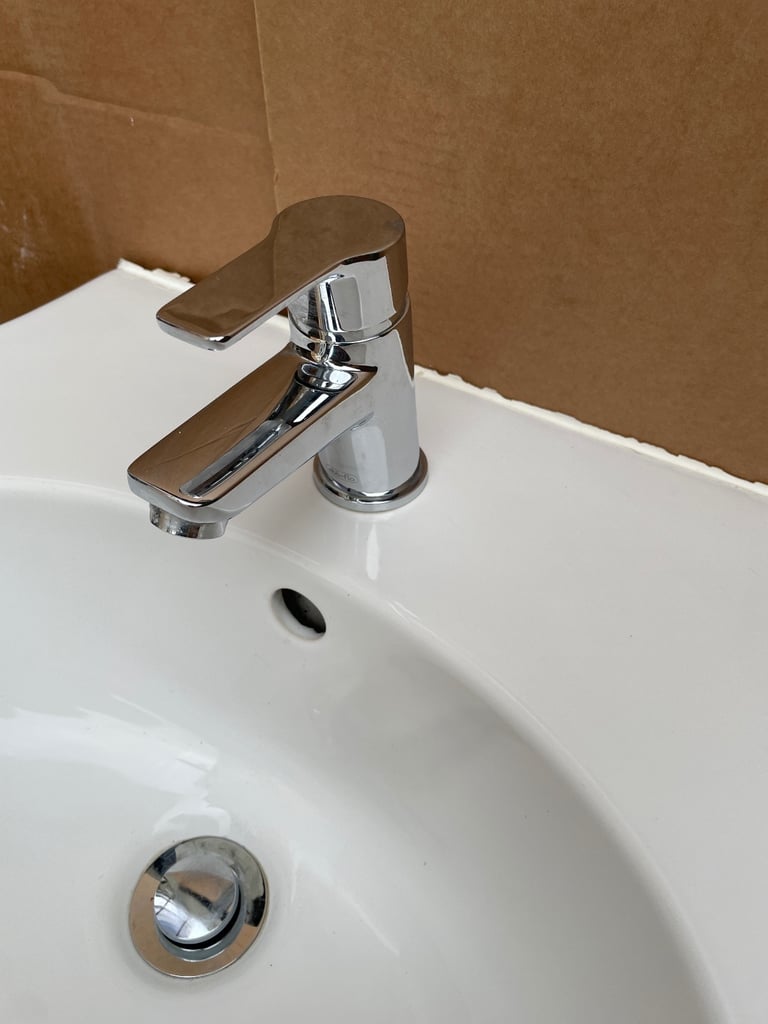 Basin with pedestal and tap