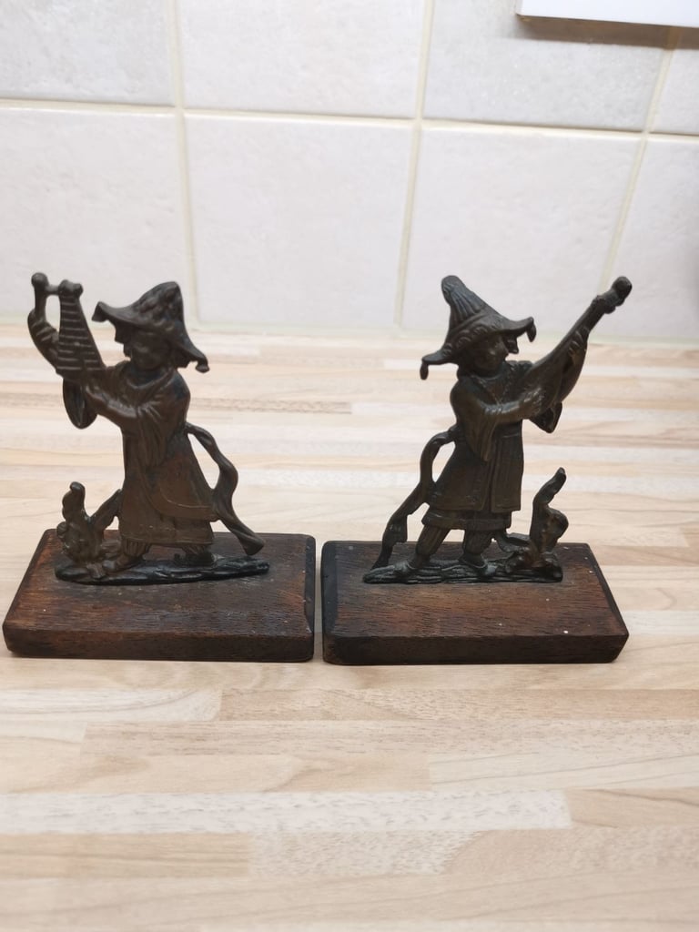 Two mounted bronze 19th Century musician ornaments with a metal plaque