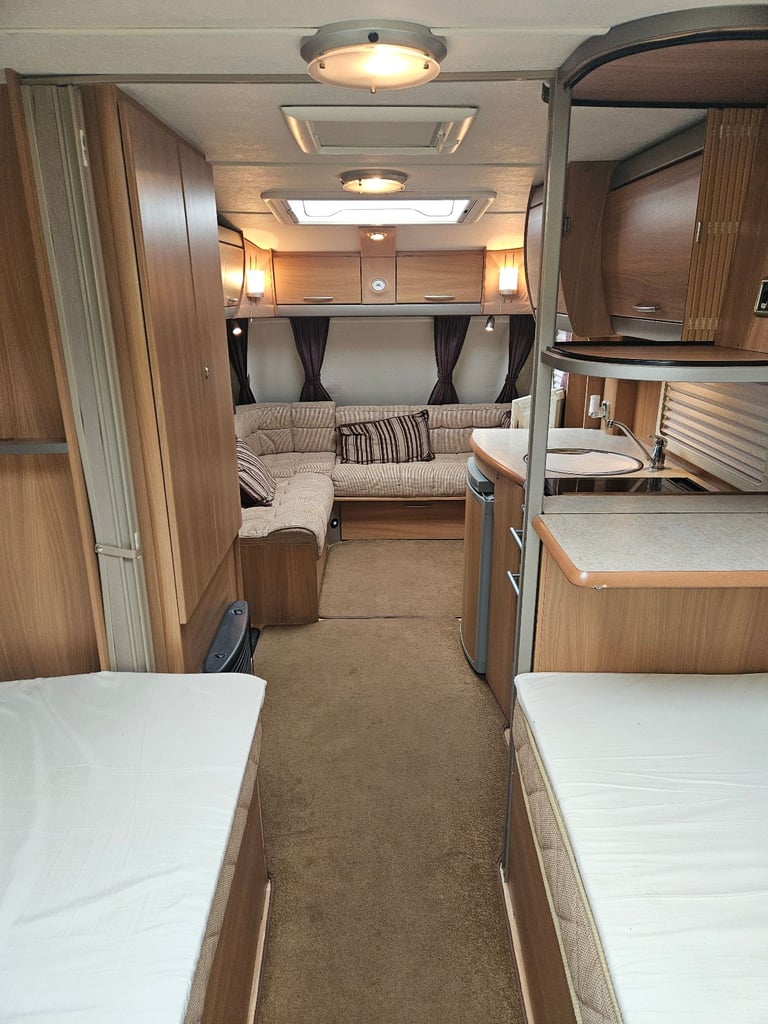 Four berth, fixed single beds, touring caravan with awning and accessories 