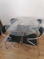 Glass round dining table with 4 padded chairs