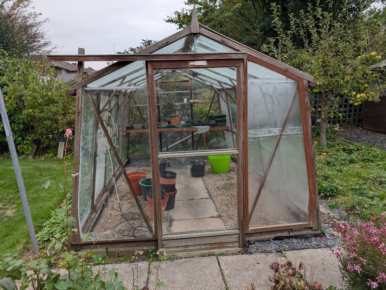 Free wooden framed greenhouse with base.