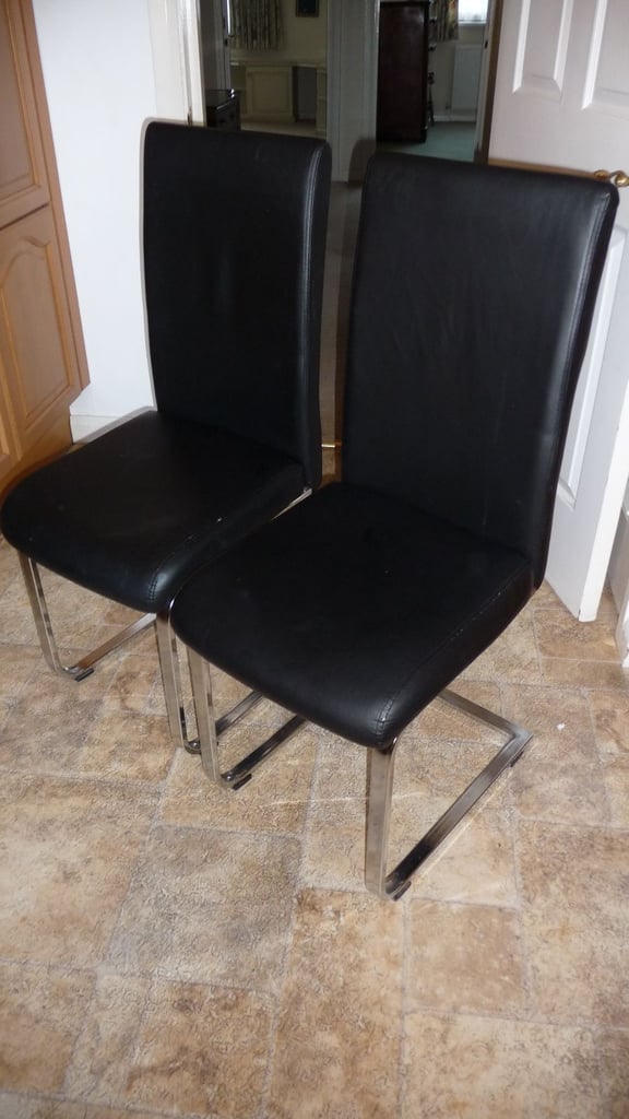 image for A pair of black padded chairs.