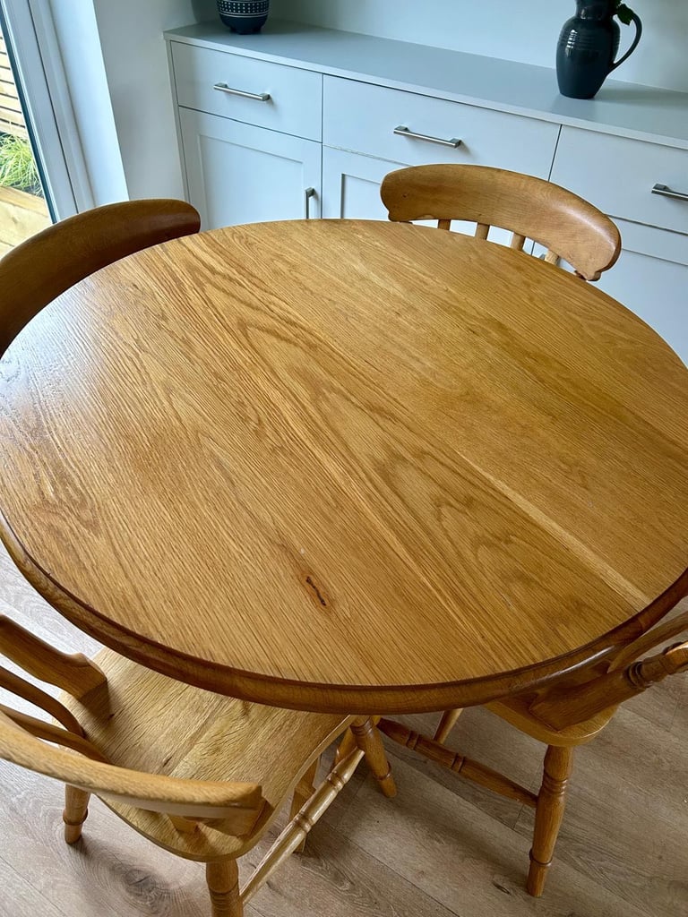 Solid oak dining table and four chairs