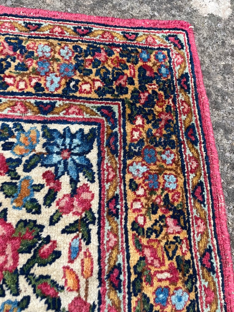A pair of Antique Kirman mats 