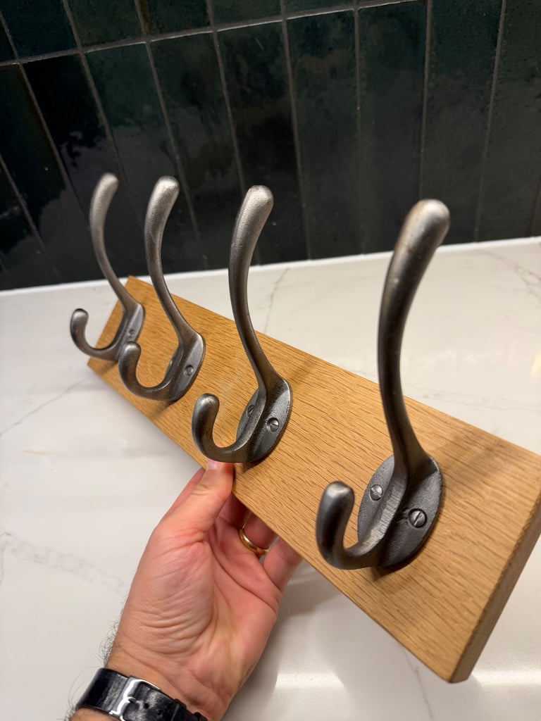 Sturdy metal coat hooks on solid wood board