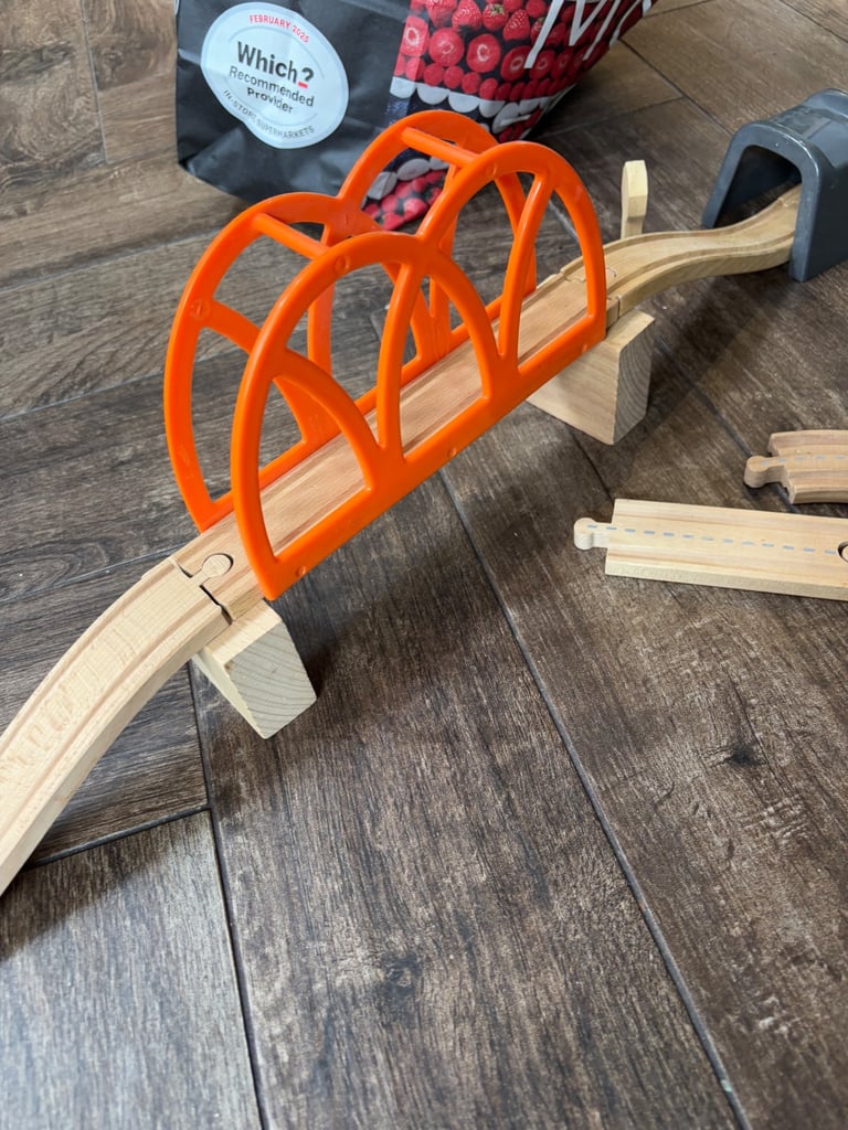 A bag full of wooden train track elements with many extras