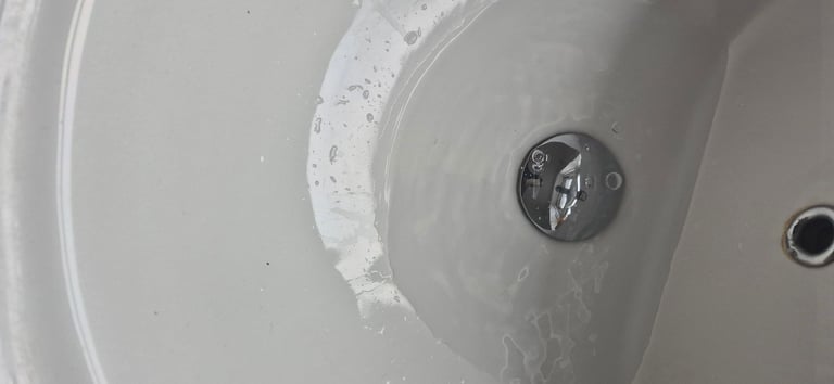 Basin with mixer tap .