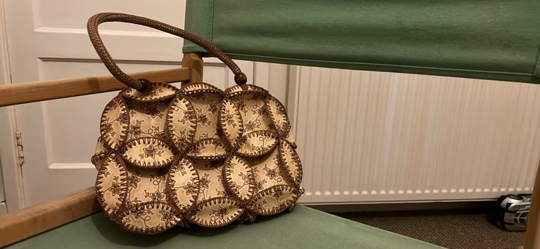 is a vintage-style patchwork bag with a bohemian aesthetic.