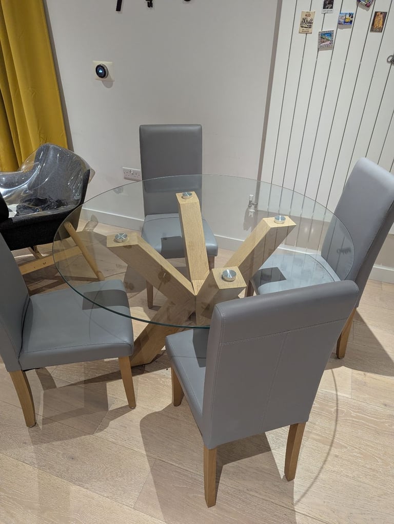 Glass round table with grey chairs