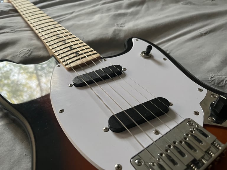 Squier by fender mustang electric guitar in sunburst