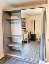 Luxurious sliding wardrobe with mirrored shelves and rails