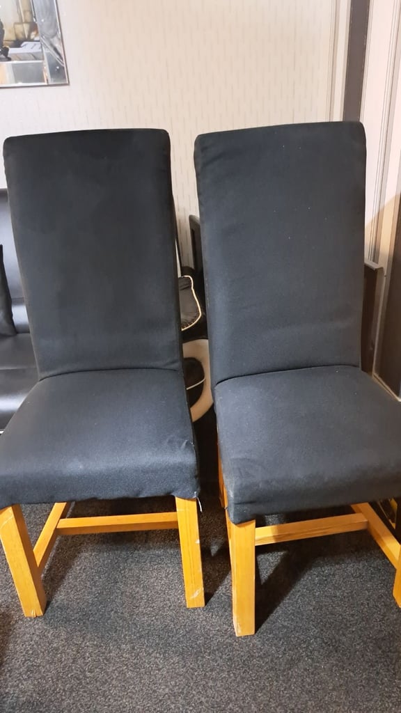 Two black solid chairs. 