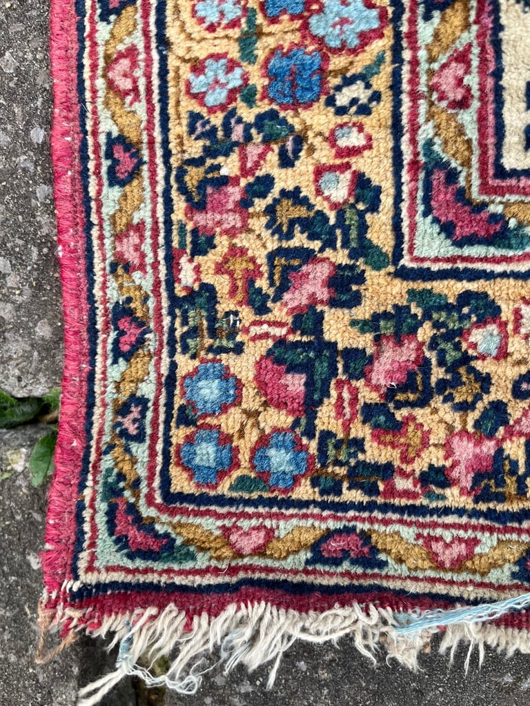 A pair of Antique Kirman mats 