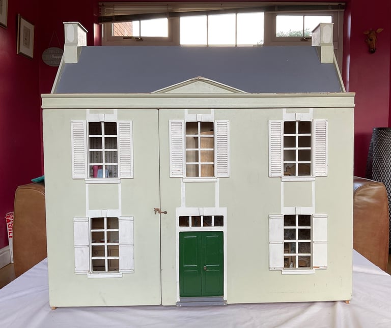 Handmade wooden dolls house with furniture and family