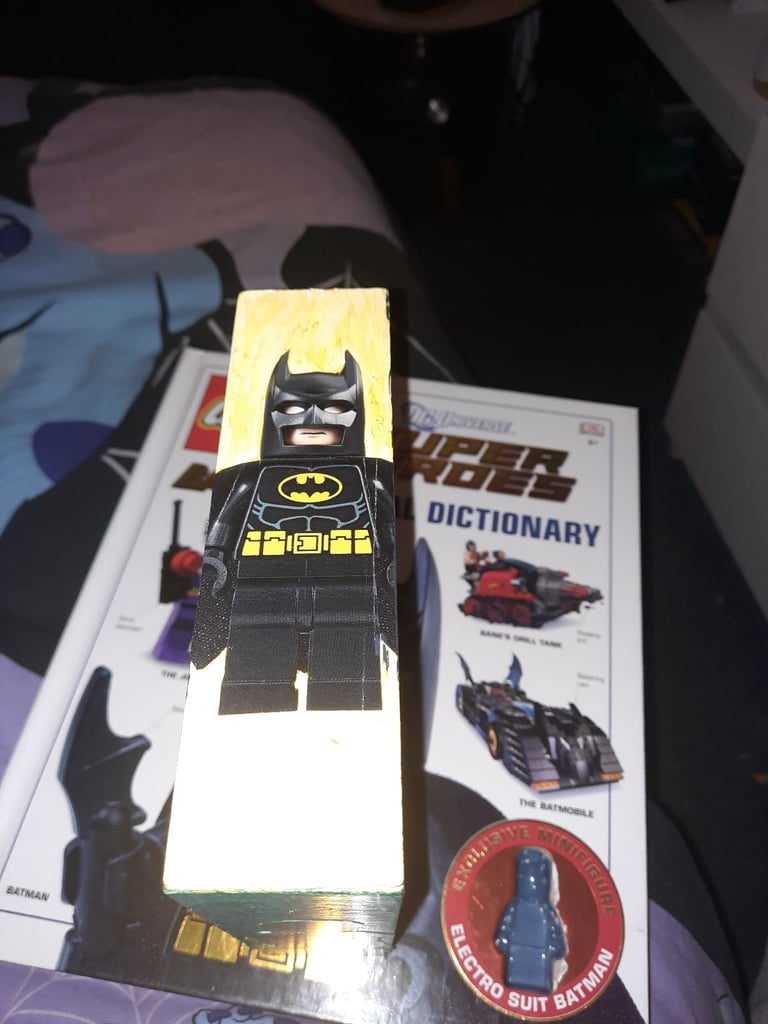 1960 & 2006 batman lego minifigures in a display case 