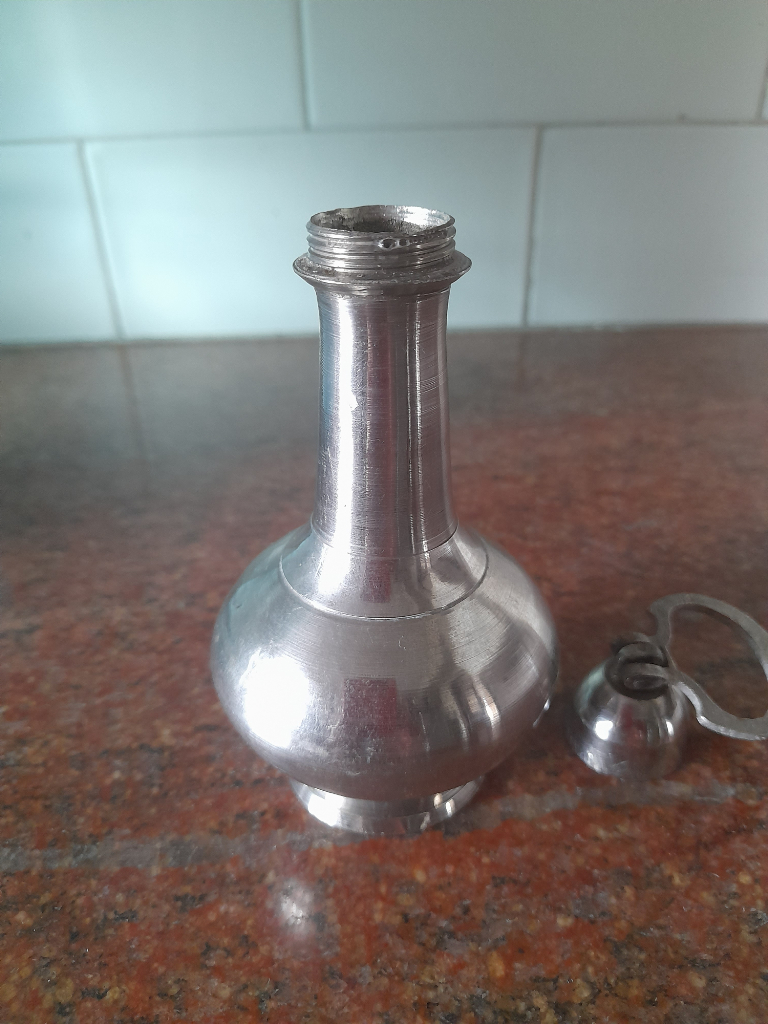 Stainless steel bottle to hold holy or fragrance water.
