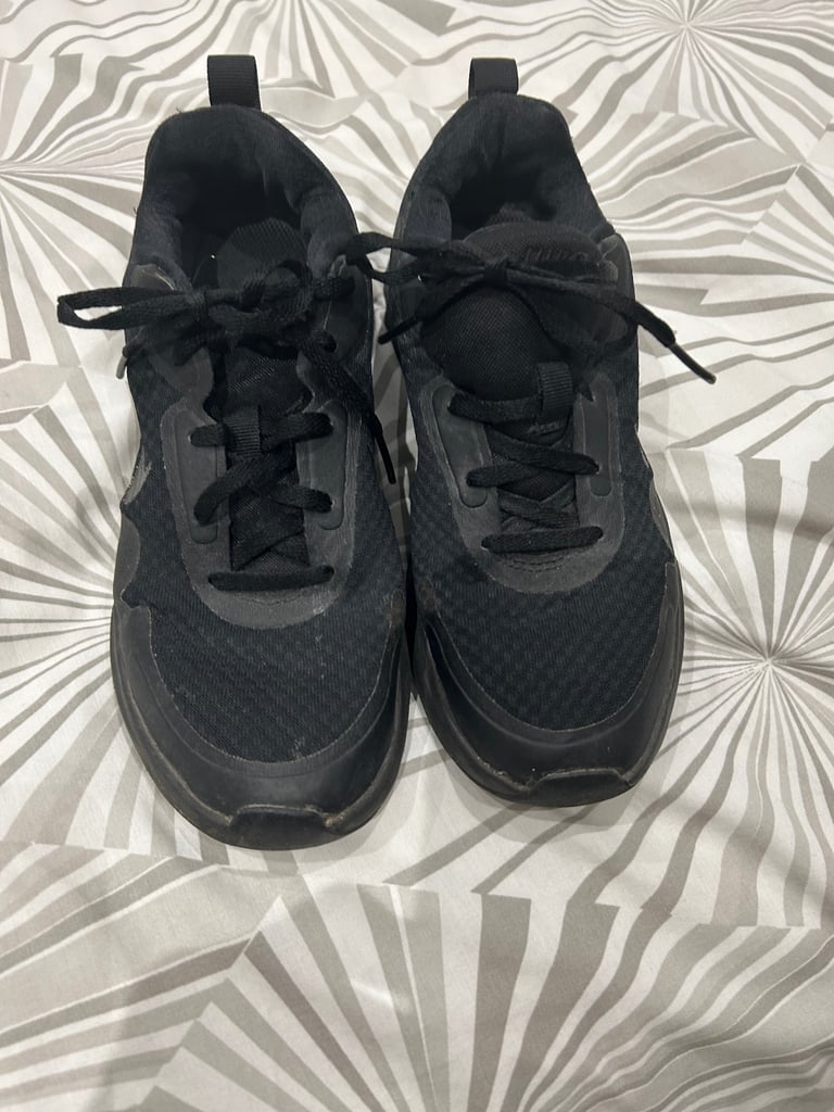 Ladies lace up Nike black trainers. Size 4