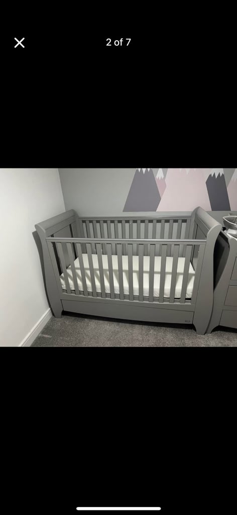 Grey cot bed with mattress available 