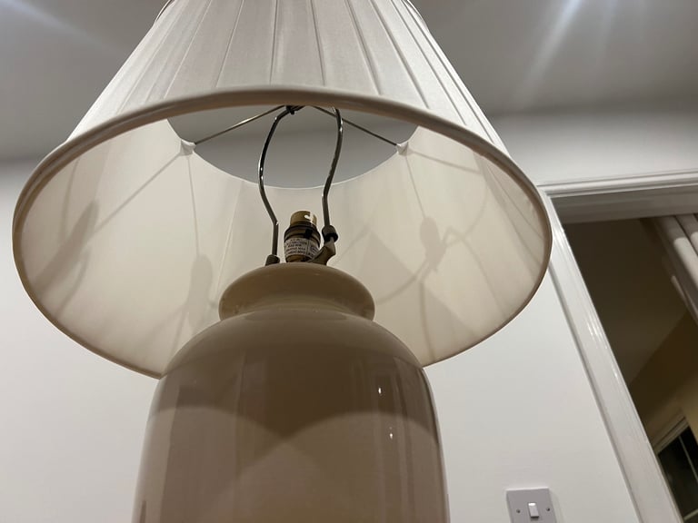Pair of Dunelm Off white ceramic lamp with brass fixtures .