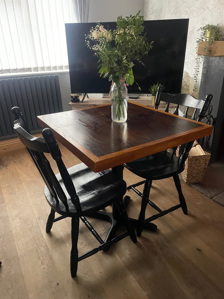 image for Wooden dining table with two black wooden dining chairs 