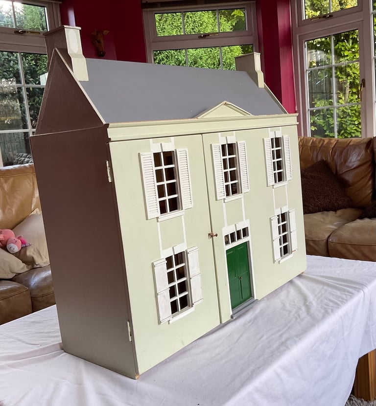 Handmade wooden dolls house with furniture and family