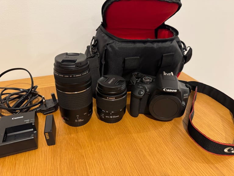 Canon EOS 2000D DSLR camera with two canon lenses.