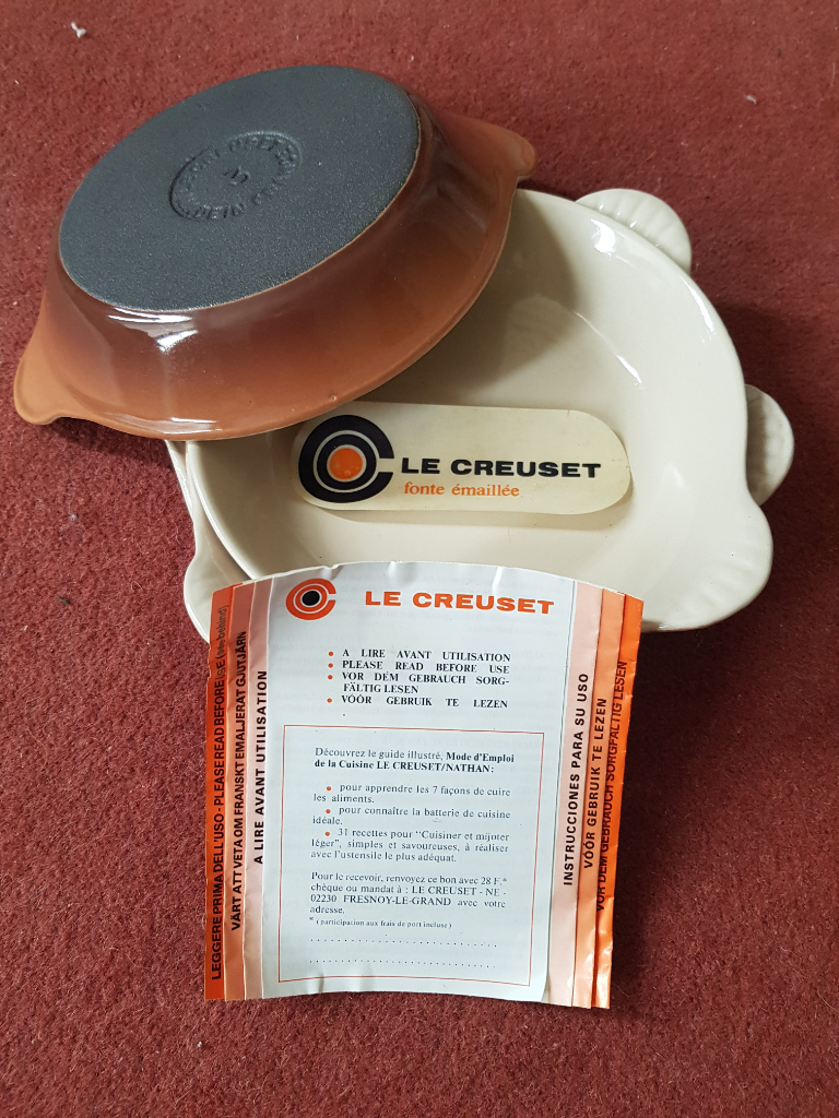 Four Le Creuset vintage light brown enamelled cast iron dishes with leaflet