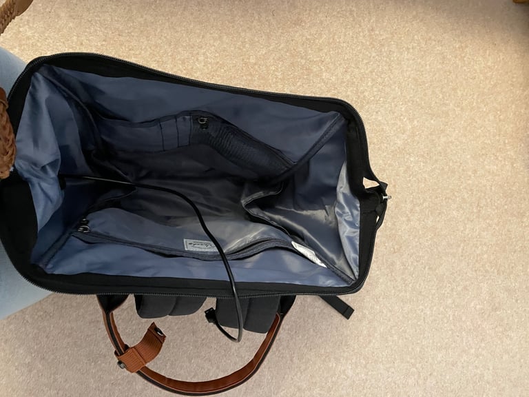 Waterproof black backpack with brown handles etc