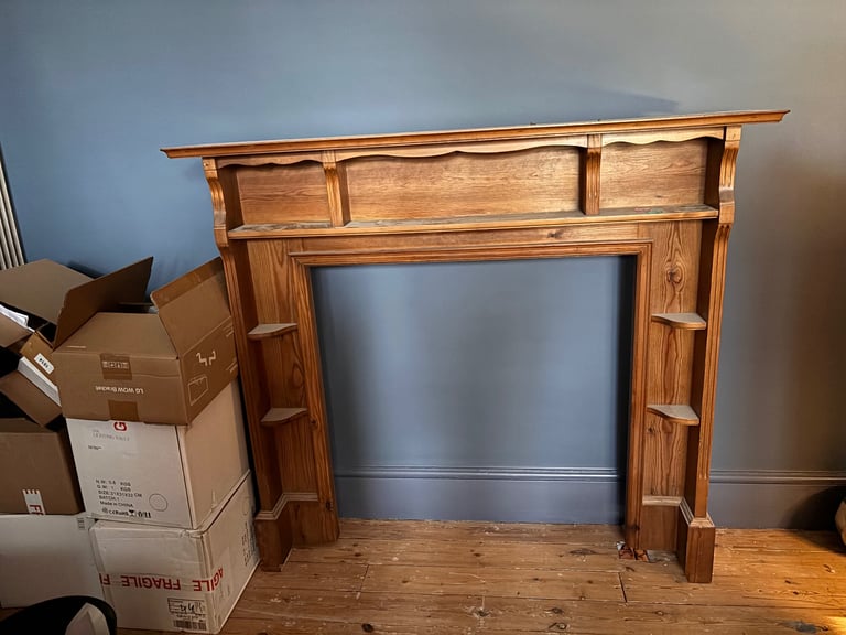 Wooden fireplace surround mantelpiece with shelves