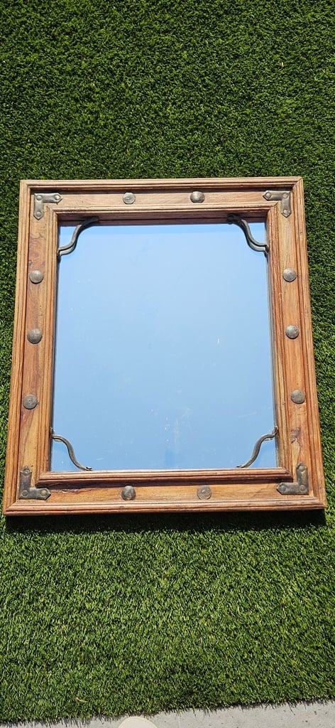 Wooden mirror with metal stud detailing