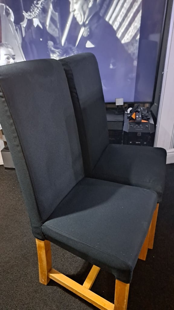 Two black solid chairs. 