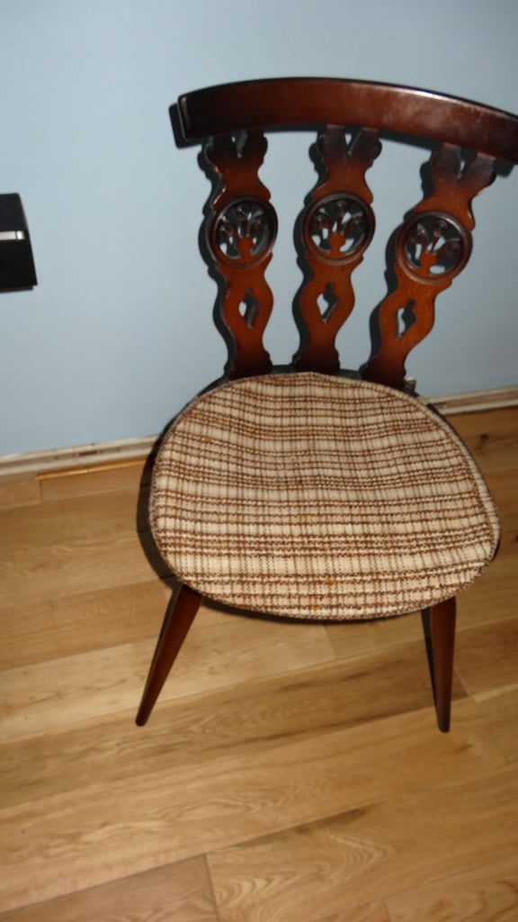 This is a set of four vintage Ercol dining chairs from the 1960s. 