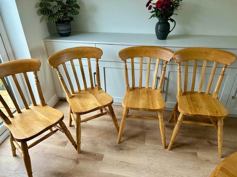 Solid oak dining table and four chairs