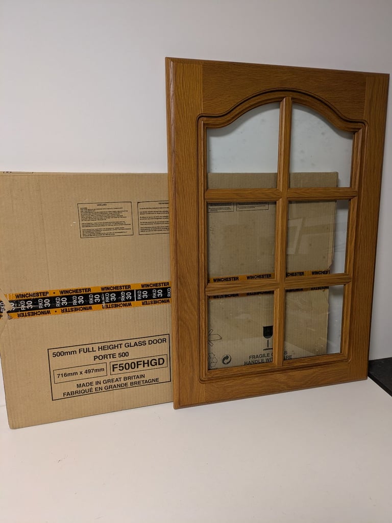 Three unused kitchen cabinet doors. One Solid Oak Glazed. Two Shaker Style White. 