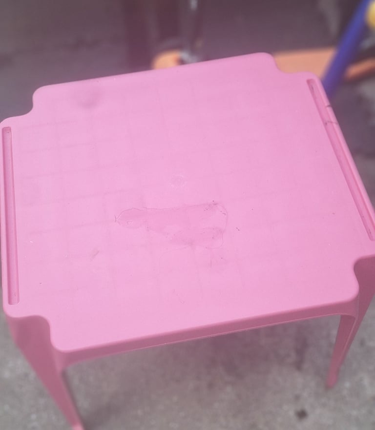 Pink kids table and red chair 