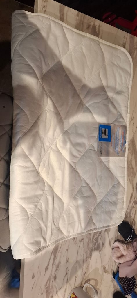 Travel cot with mattress and mattress topper 