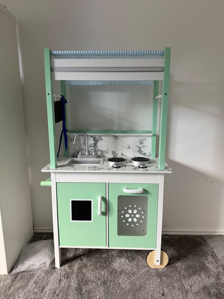 Toy kitchen with food and pots and pans 