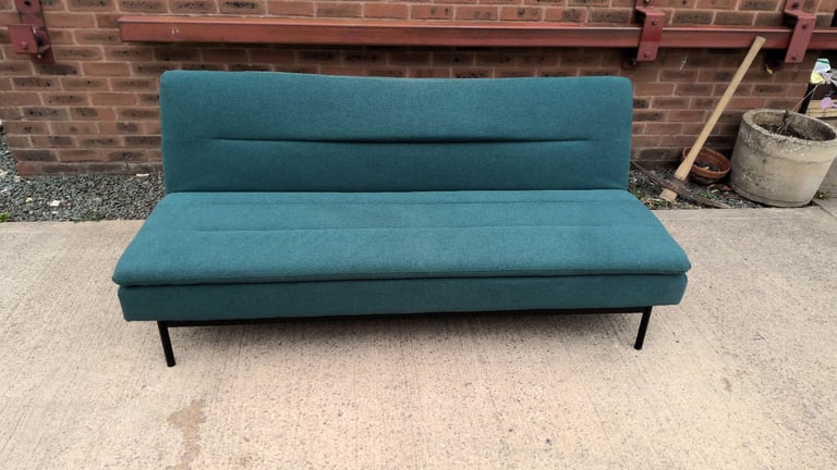 green 2 seater sofa that folds down to be a sofa bed 