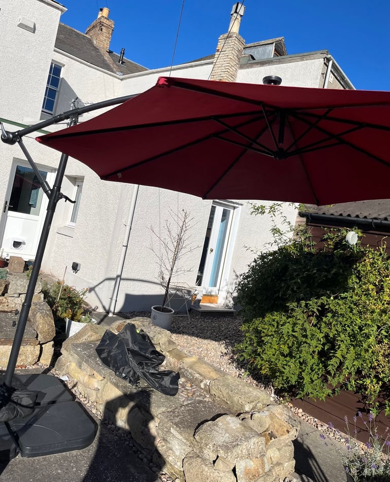 Large garden parasol with base weights and cover