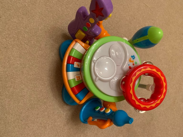 Drum, keyboard tambourine, guitar, maraca and trumpet musical toys
