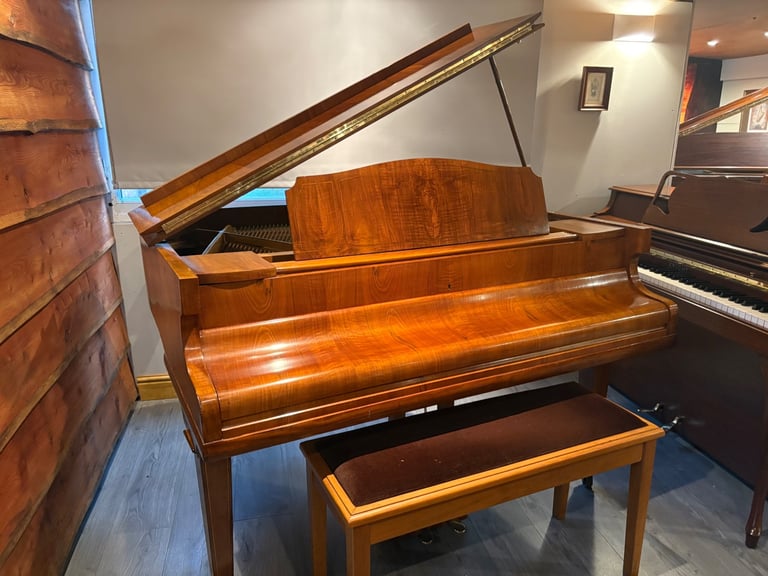 Stunning walnut baby grand Piano with matching stool.