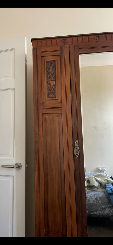 Beautiful dark wood wardrobe with carved flower inlay 