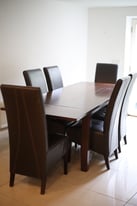 Extendable wooden dining table and six leather chairs (House of Fraser)