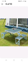 Camping Folding table with integral bench chairs.