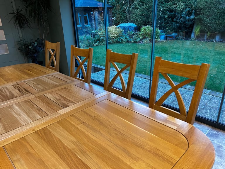 Solid oak dining table and six chairs