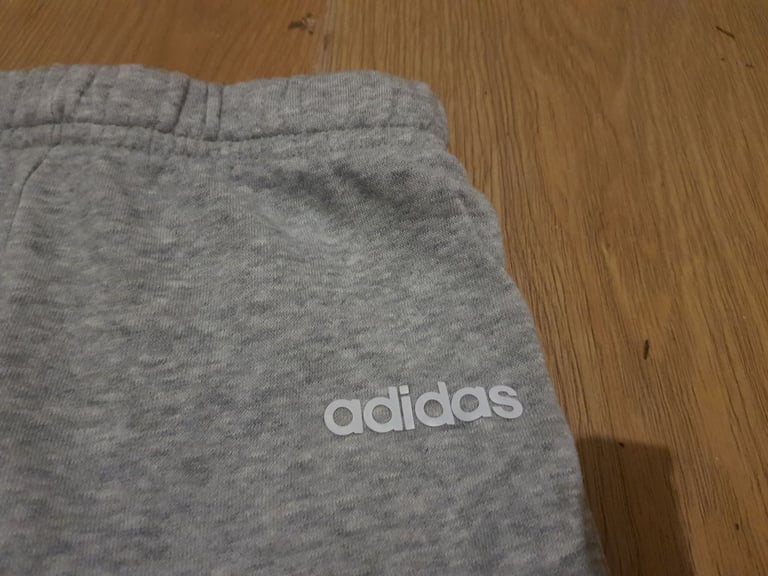 Childrens unisex Adidas grey jogging bottoms.