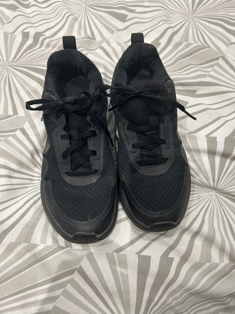 Ladies lace up Nike black trainers. Size 4