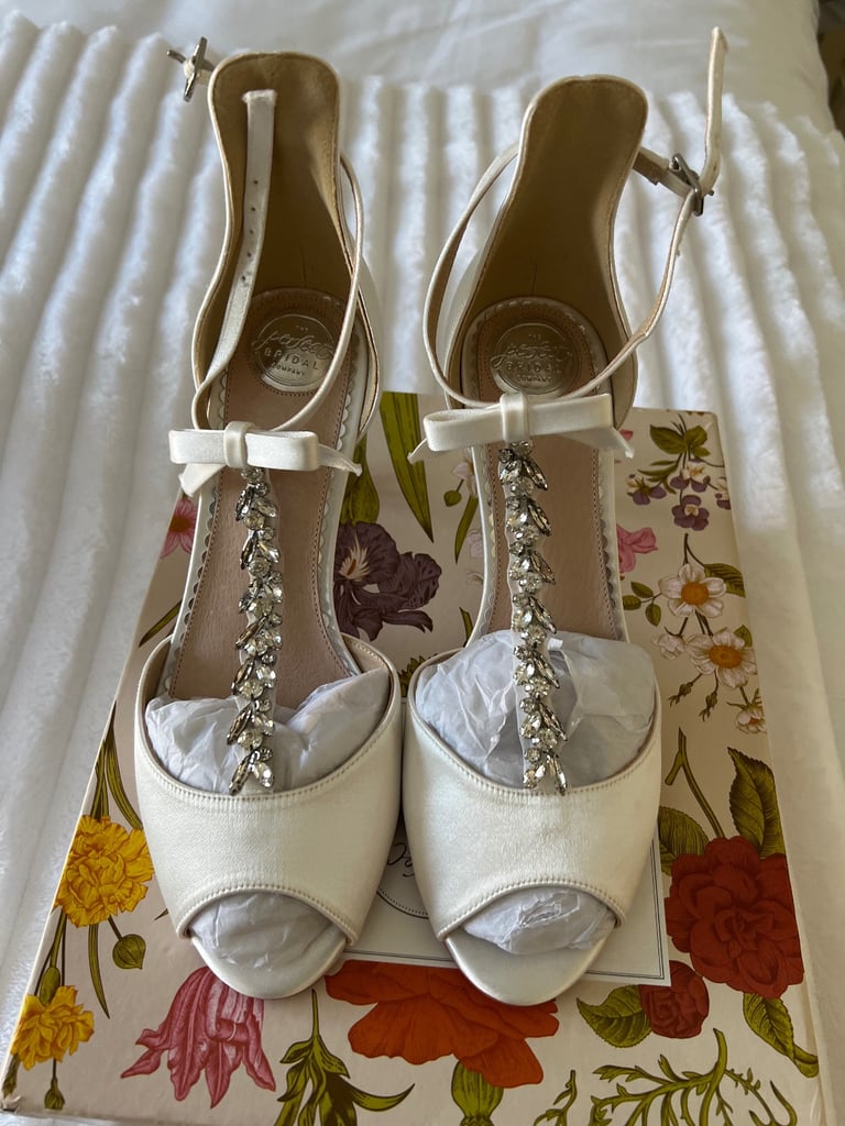 White satin heeled shoes